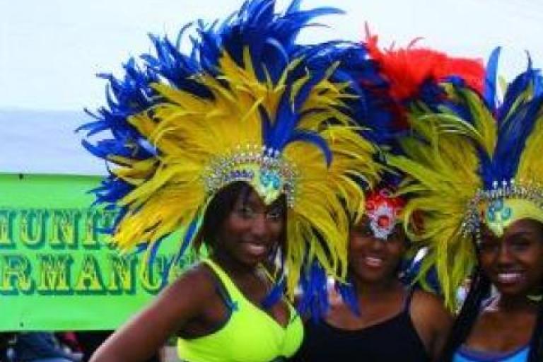 Women with carnival headdresses smiling