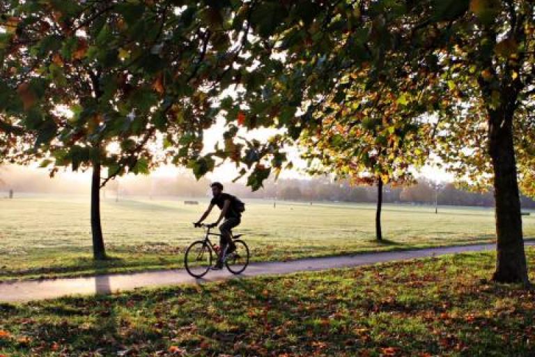 a person cycling across clapham common