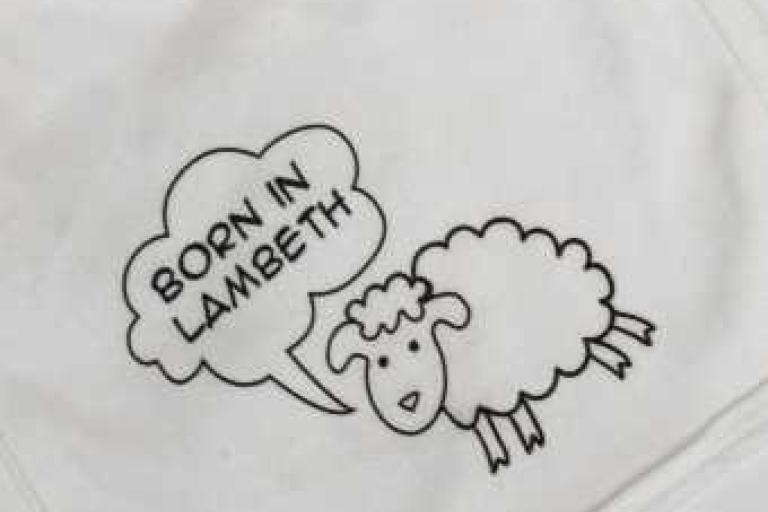 Born in Lambeth undated sheep bib in white - close up
