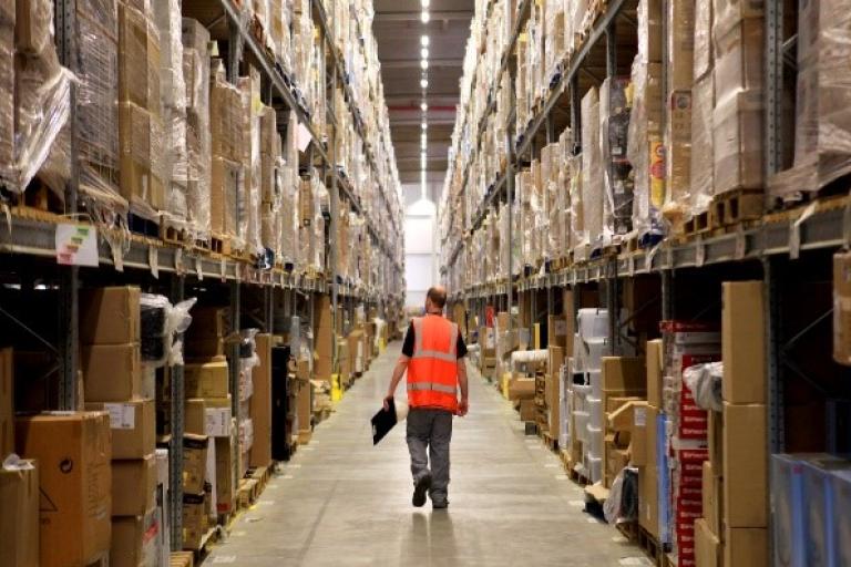 A man walking through a warehouse