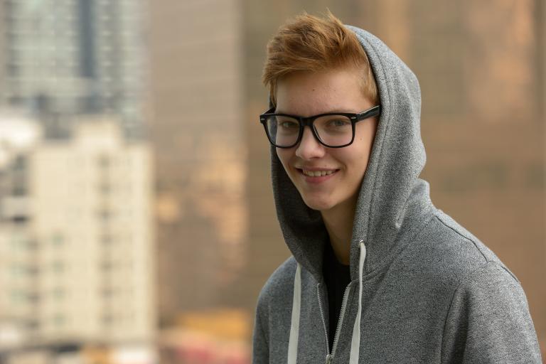 Smiling young male with hoodie on