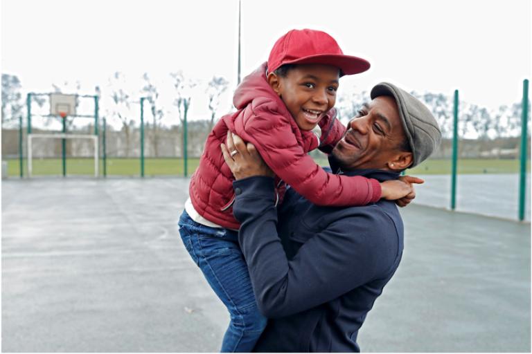 Child and dad hugging