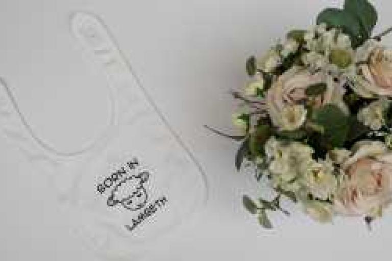 Born in Lambeth lamb bib in white with flowers