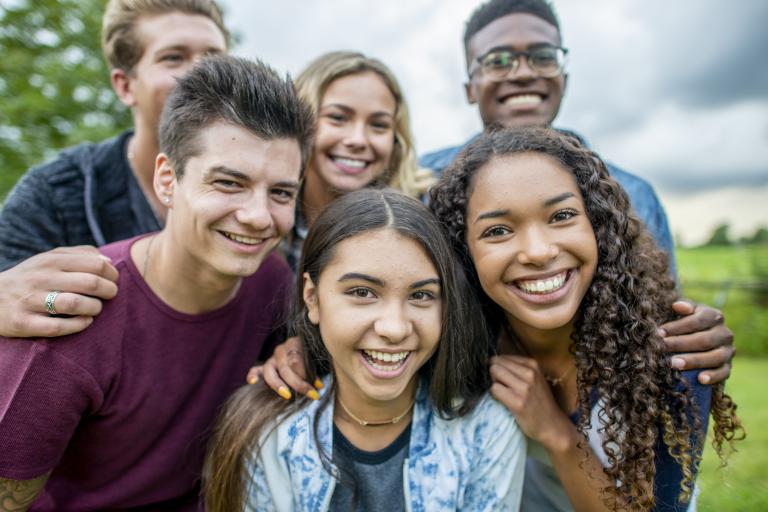 Ethnically diverse group of teenagers smiling