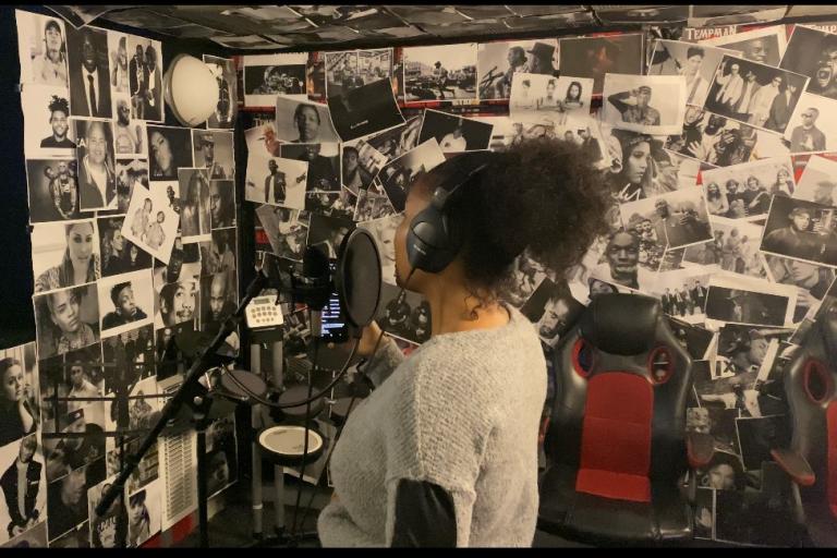 Woman in a recording studio singing