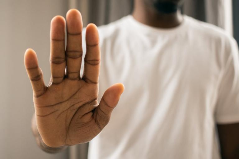 Man holding hand up as stop sign