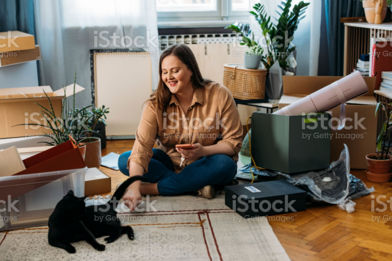 woman in a home petting a cat