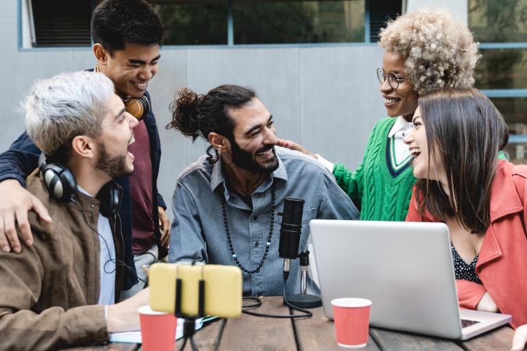 Young people laughing at work