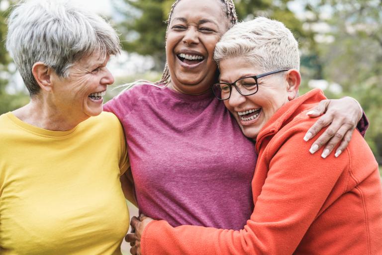 Old female friends hugging