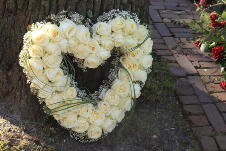 Heart shaped wreath resting against tree