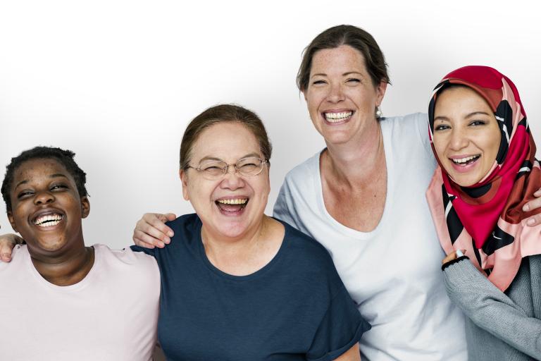 Group of adults laughing and smiling at the camera