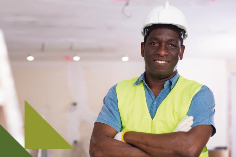 Man with hardhat on smiling at camera