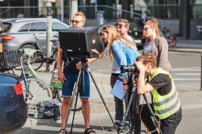 Crew filming and taking photos on a street