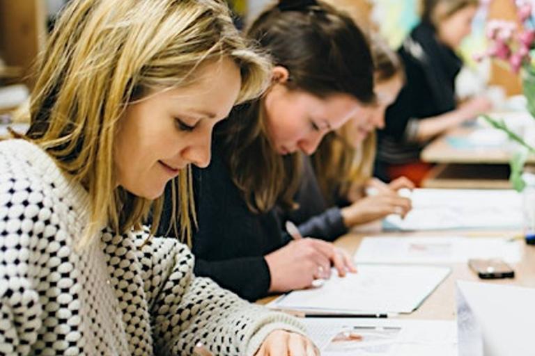 a group of students learning to papercut at an art workshop