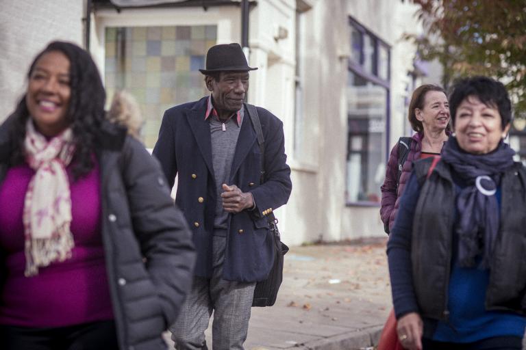 Group of older people walking to event