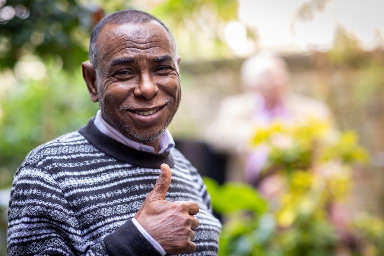 Man in park doing thumbs up