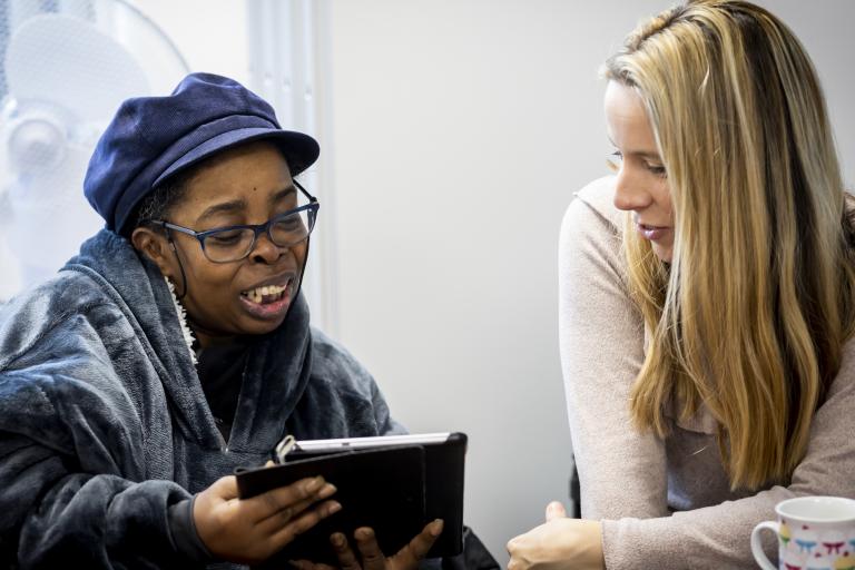 Women looking at ipad and discussing something