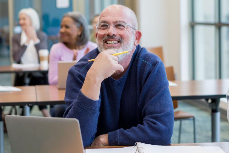 Digital training with adults, man smiling at screen