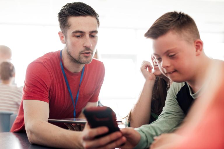 Man showing a child information on a phone