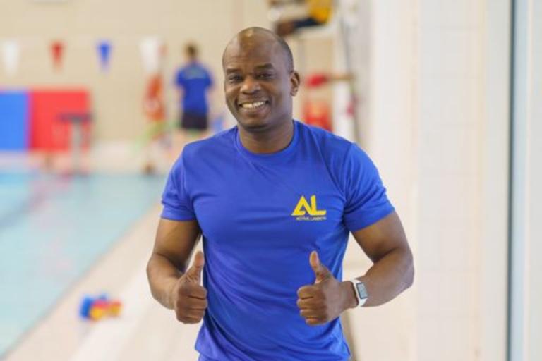 Lifeguard by the pool giving a thumbs up