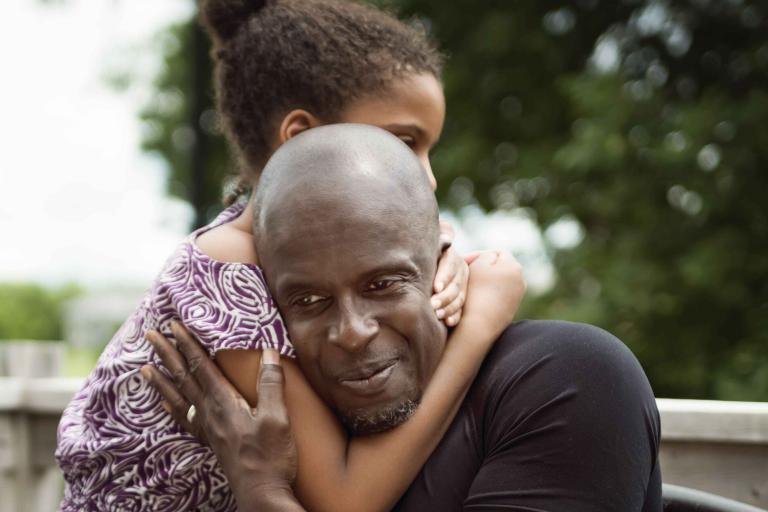 child embracing an adult