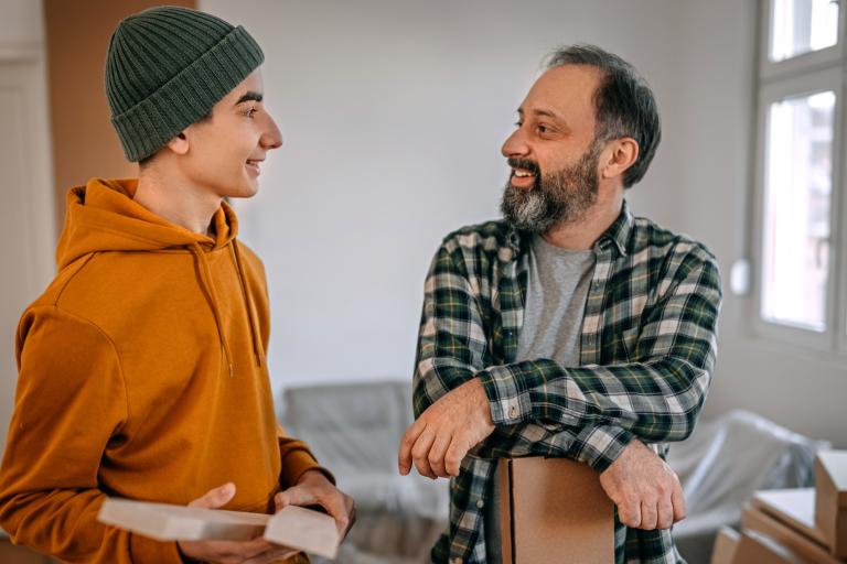 Young person and adult talking and smiling