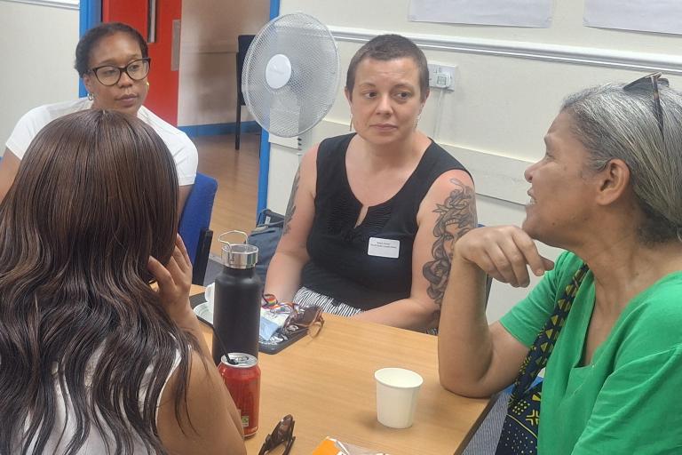 Group sitting around a table and talking
