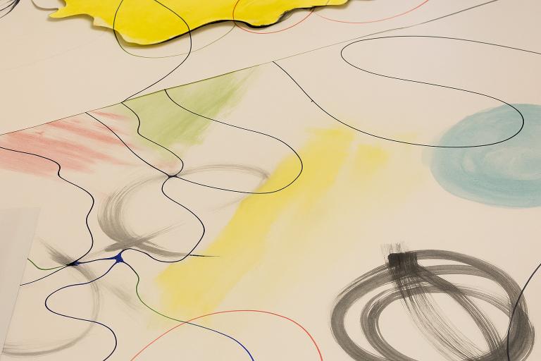 Abstract artwork with wavy black lines and soft patches of colour, including yellow, green, blue, and pink. A bright yellow piece of paper lies on top near the upper edge. This piece featured in the World Refugee Week art exhibition  