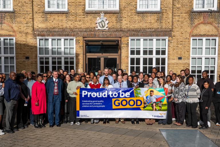 Lambeth staff and cllrs holding banner to celebrate Good ofsted rating - proud to be Good