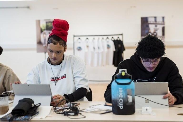 Young people sat at desk working