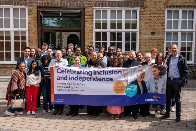 Adult Social Care staff outside Lambeth Town Hall holding banner