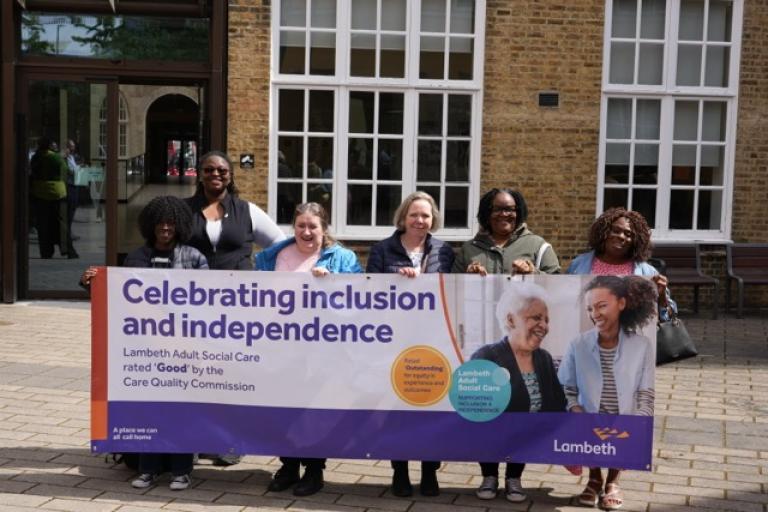 Local carers hold celebratory banner outside Lambeth Town Hall