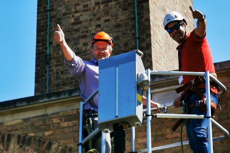 Cllr Abrams and Dr Ian Boulton install a swift box on roof of house