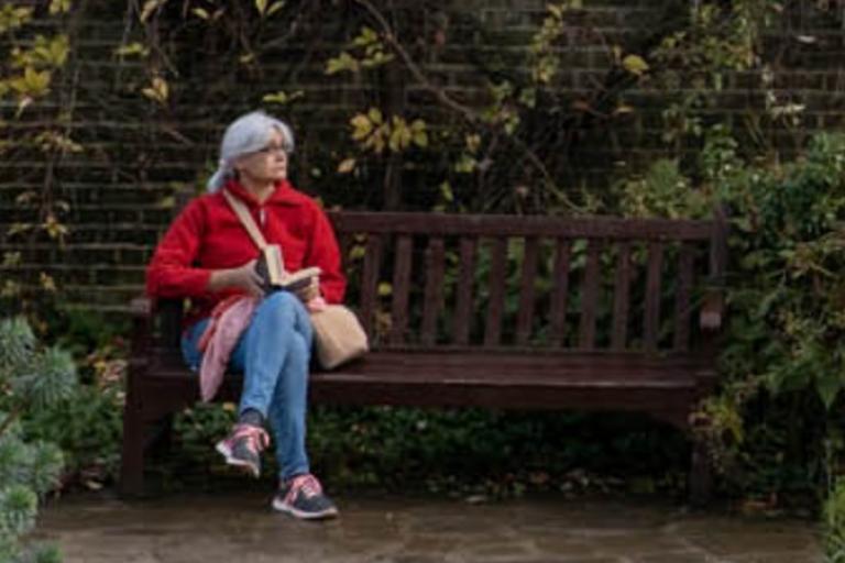 Woman sitting on park bench