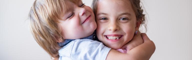 Children hugging and smiling