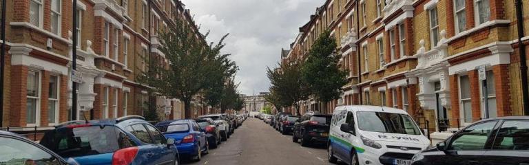 Parked cars on a road in Brixton