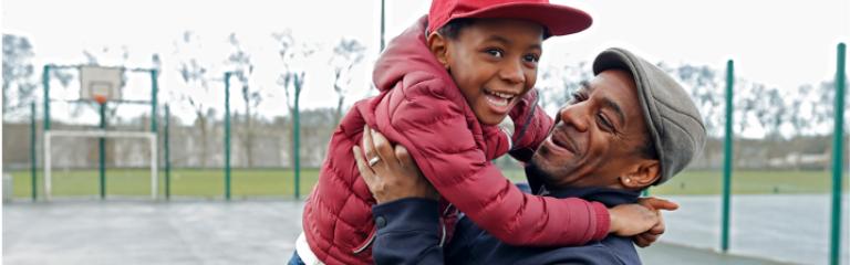 Child and dad hugging