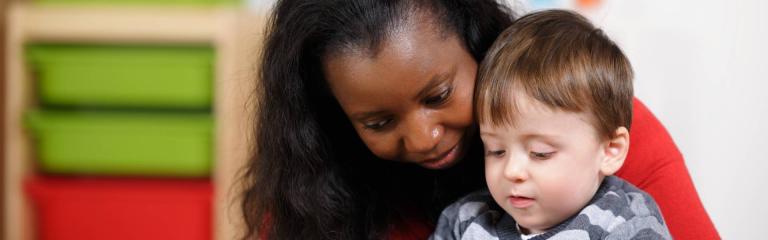 Woman reading to child on her lap