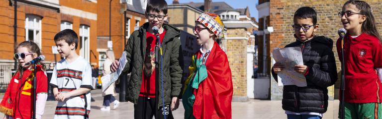 Children singing at outdoor event