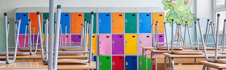 Chairs on table with coloured lockers in the background
