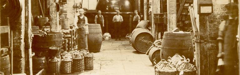 Vintage photo of men in brewery with barrels