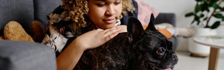 Woman on sofa with pet dog