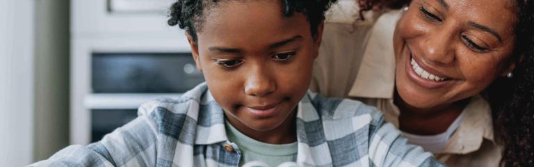 Child and adult sitting on a table