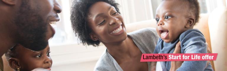 Family smiling at laughing baby