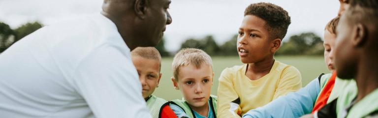 Carer with young people outdoors