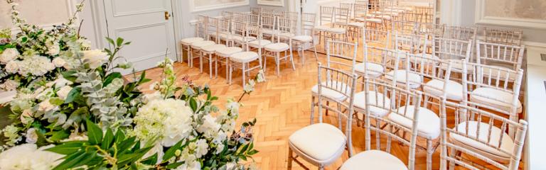 Room with decorations and chairs set up for a ceremony 