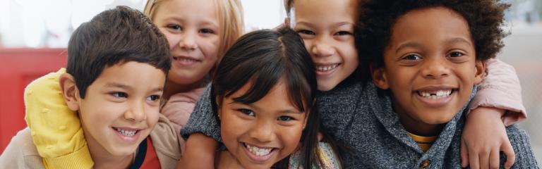 Children huddled in group smiling