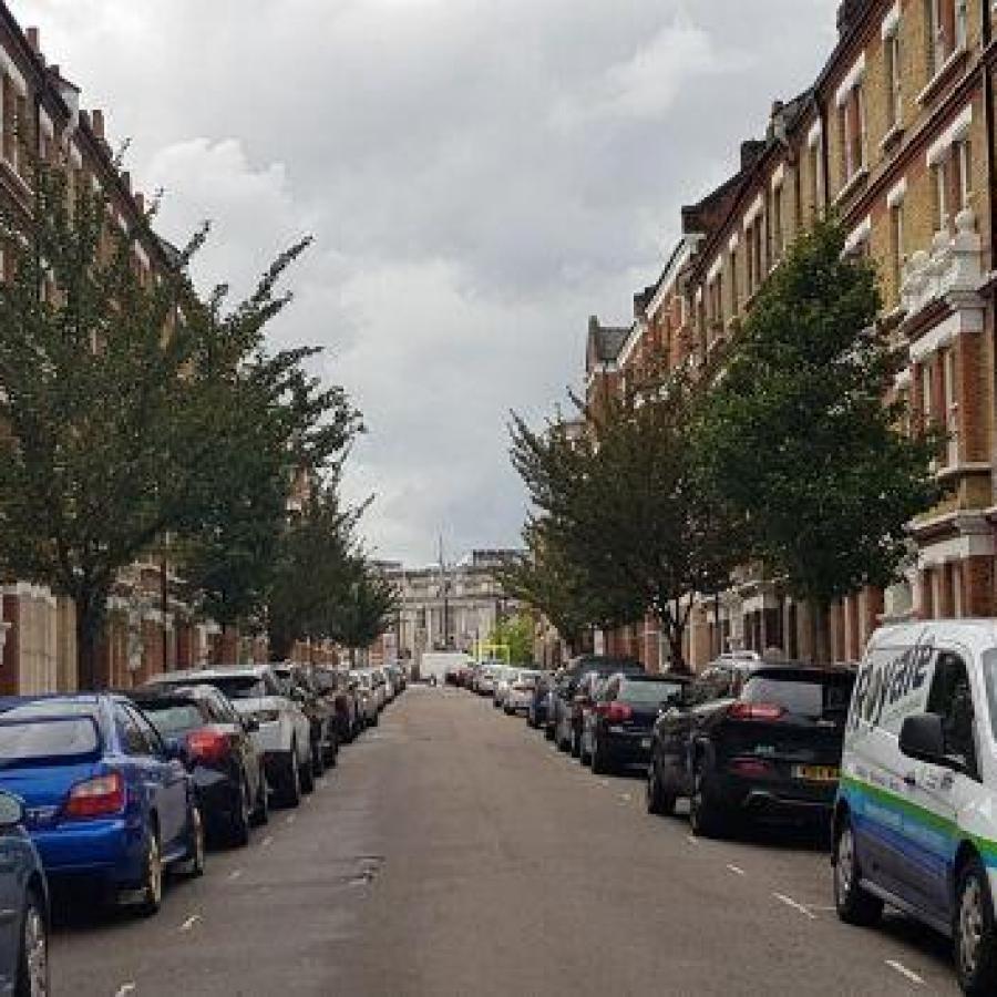 Parked cars on a road in Brixton 
