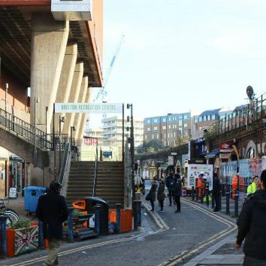 People walking through Brixton Station Road Market 
