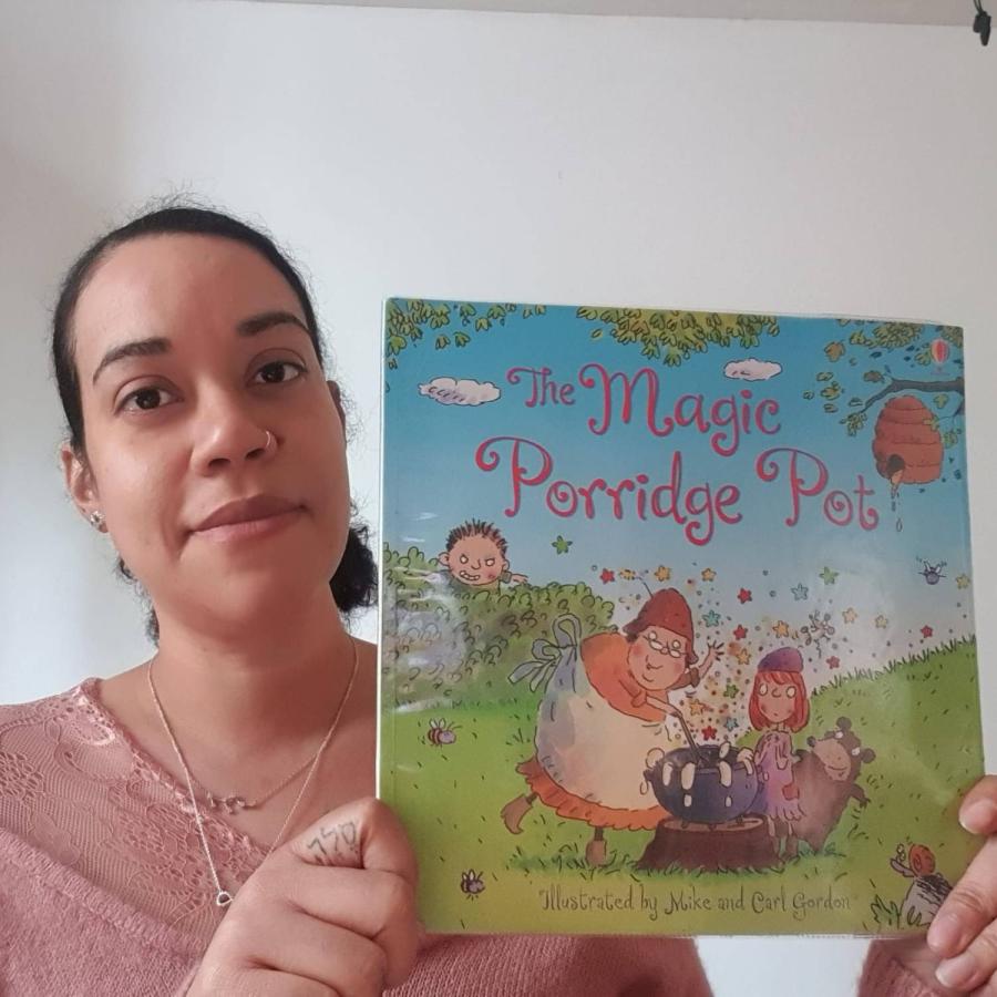 Tamika showing of Magic Porridge pot book
